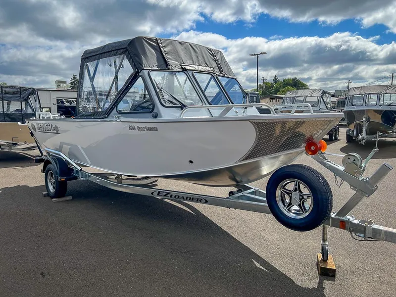 Slide: The Image of 2024 Hewescraft 200 Sportsman boat on trailer under cloudy sky. - 6