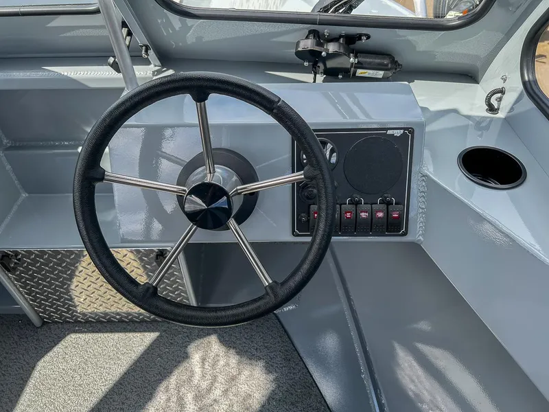 Slide: The Image of 2024 Hewescraft 200 Sportsman boat dashboard with steering wheel and control panel. - 9