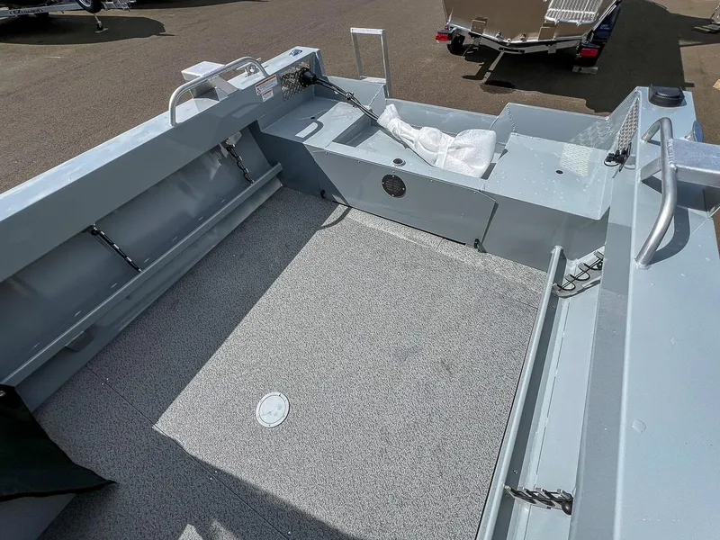 Slide: The Image of 2024 Hewescraft 200 Sportsman boat interior with spacious deck and storage compartments. - 14