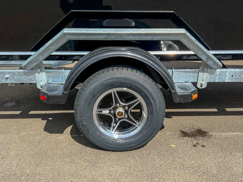 Slide: The Image of 2024 Hewescraft 200 Sportsman trailer wheel and fender on asphalt. - 18