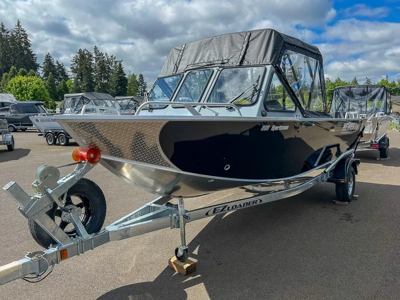 Slide: The Image of 2024 Hewescraft 200 Sportsman boat on EZ Loader trailer in outdoor lot. - 6