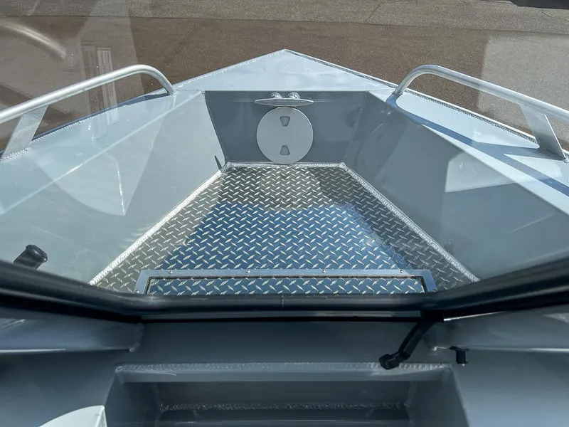 Slide: The Image of 2024 Hewescraft 200 Sportsman boat interior with diamond plate flooring. - 7