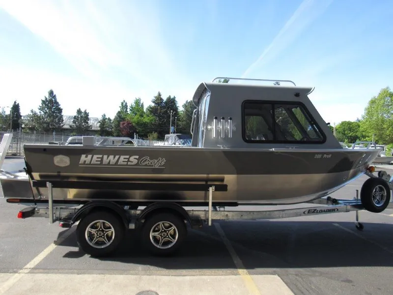 Slide: The Image of 2024 Hewescraft 200 PRO V ET HT boat on a trailer in a parking lot. - 6