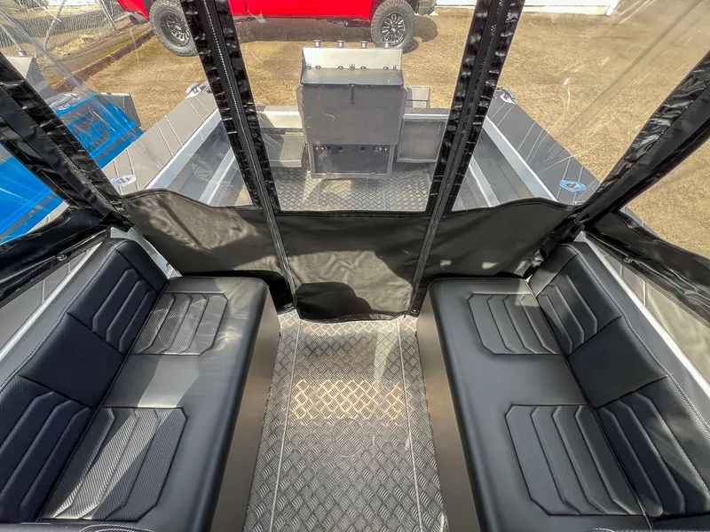 Slide: The Image of Interior of 2024 Stabicraft 2050 Treker Sportfish with black seating and diamond plate flooring. - 12