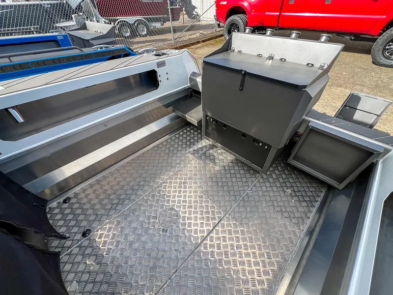 Slide: The Image of 2024 Stabicraft 2050 Treker Sportfish interior with aluminum flooring and storage compartments. - 14