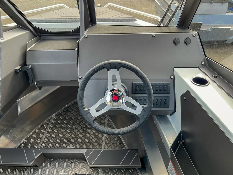 Slide: The Image of 2024 Stabicraft 2050 Treker Sportfish dashboard with steering wheel and control panel. - 8