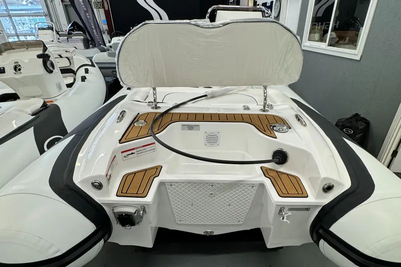 Slide: The Image of 2024 Walker Bay Gen 13 LTE boat interior with steering wheel and seating. - 3