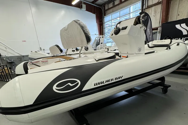 Slide: The Image of 2024 Walker Bay Gen 13 LTE boat with Honda outboard motor, sleek design. - 4