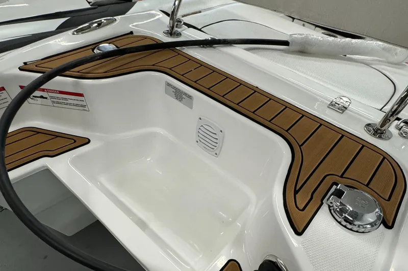 Slide: The Image of 2024 Walker Bay Gen 13 LTE inflatable boat in showroom, featuring sleek design and modern seating. - 5
