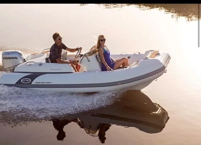 Slide: The Image of 2024 Walker Bay Gen 13 LTE boat cruising on water. - 1