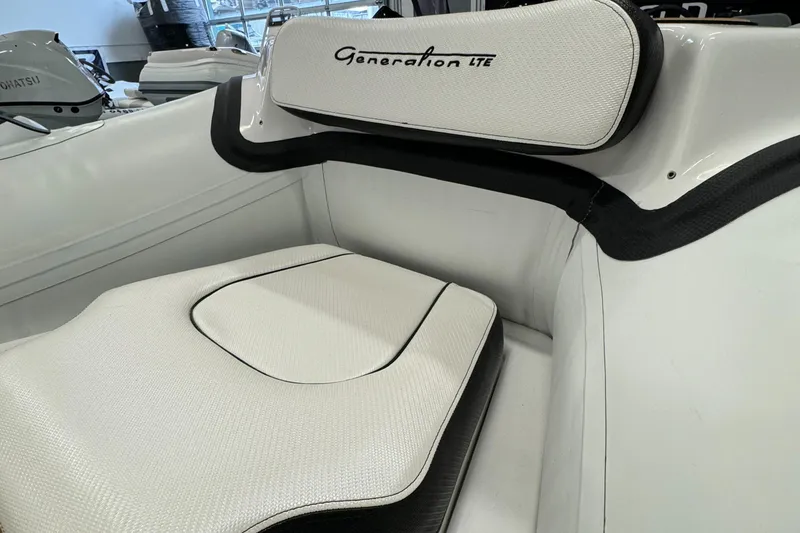 Slide: The Image of 2024 Walker Bay Gen 13 LTE boat interior with white seating and console. - 6