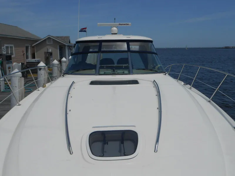 Slide: The Image of 2004 Sea Ray 420 Sundancer yacht docked at a marina. - 10