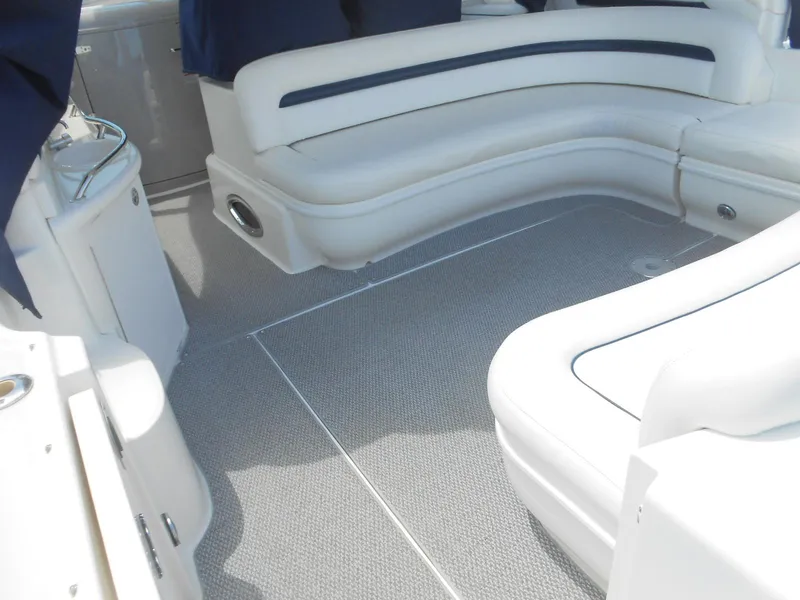 Slide: The Image of 2004 Sea Ray 420 Sundancer interior with white leather seating and grey carpet. - 12