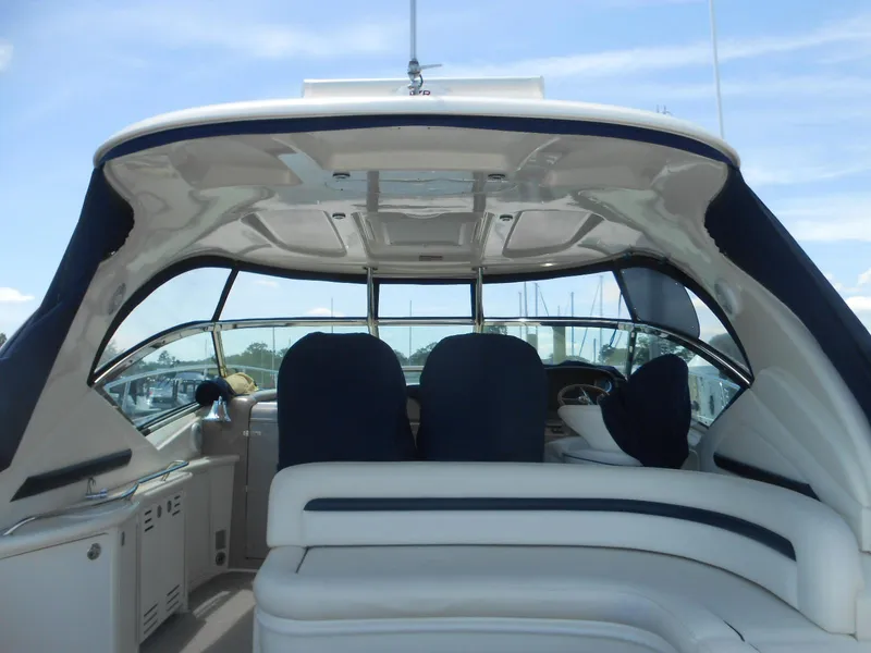 Slide: The Image of 2004 Sea Ray 420 Sundancer yacht interior with white and navy seating. - 13