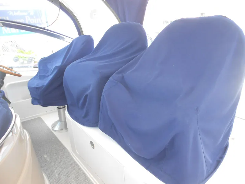 Slide: The Image of Blue seat covers on a 2004 Sea Ray 420 Sundancer boat. - 14