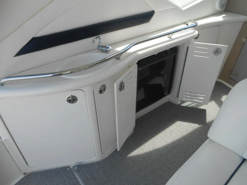 Slide: The Image of Interior of 2004 Sea Ray 420 Sundancer with open storage compartments. - 17
