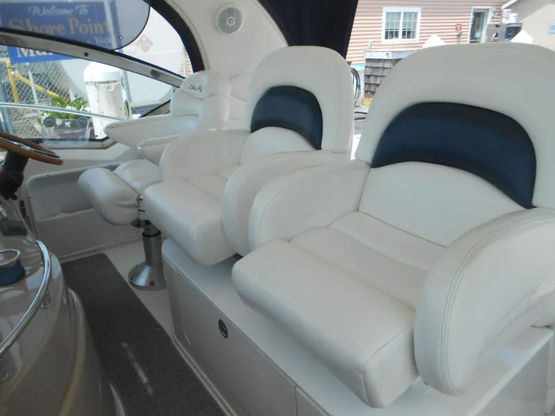 Slide: The Image of Luxurious white leather seats on a 2004 Sea Ray 420 Sundancer yacht. - 19