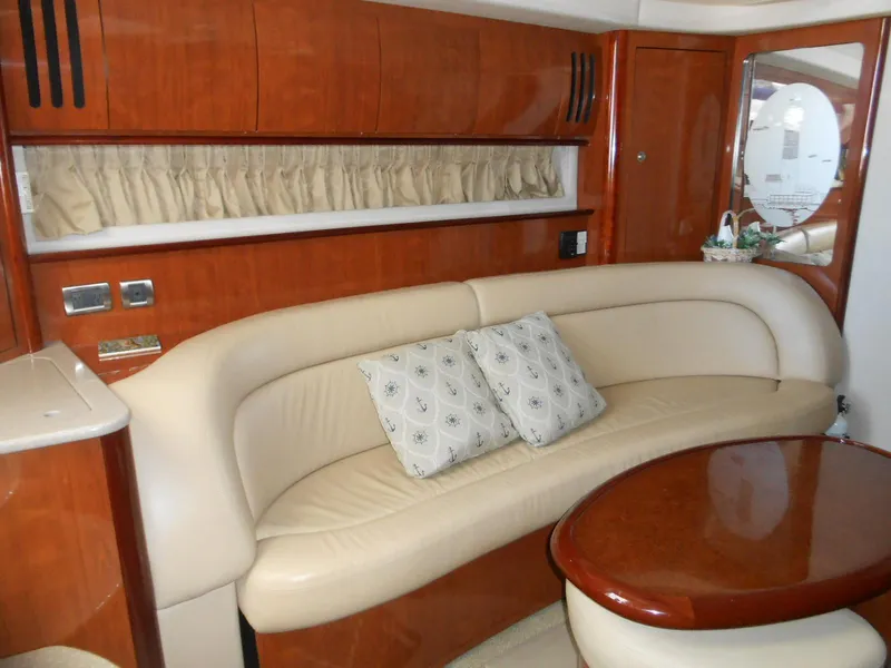 Slide: The Image of Luxurious interior of a 2004 Sea Ray 420 Sundancer yacht with leather seating and wooden finishes. - 21