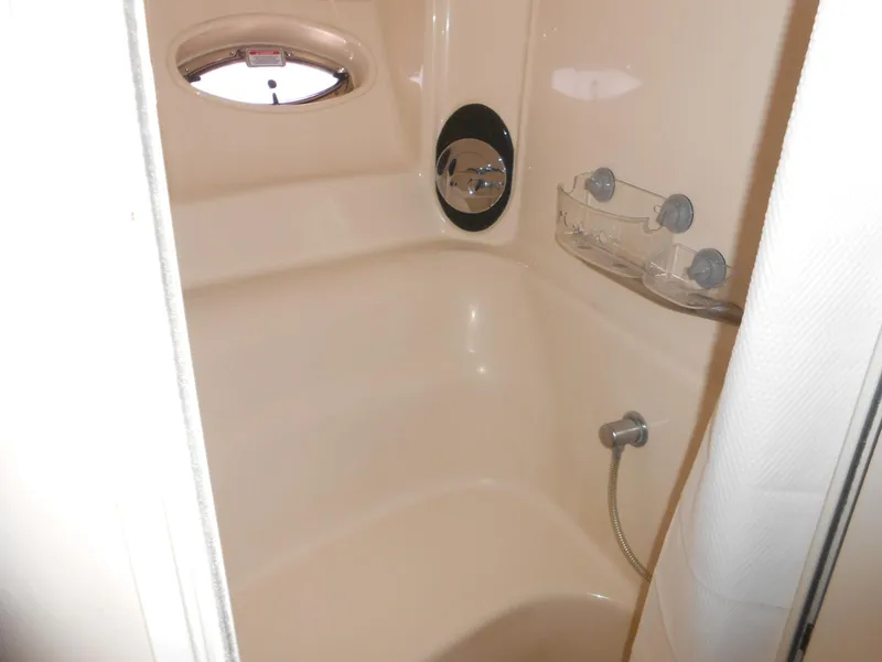 Slide: The Image of Shower area in 2004 Sea Ray 420 Sundancer yacht with porthole and fixtures. - 27