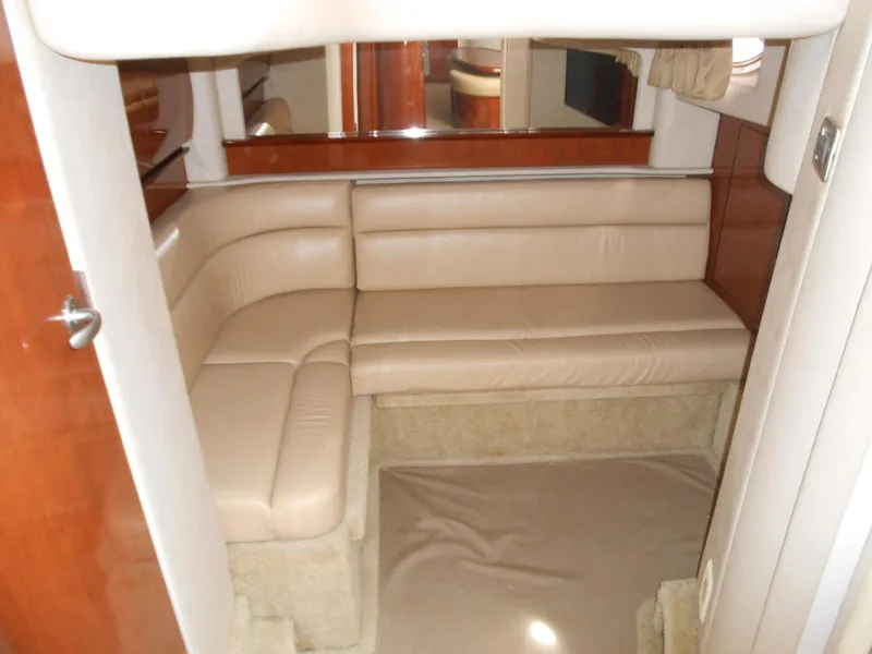 Slide: The Image of 2004 Sea Ray 420 Sundancer interior with beige leather seating and wood accents. - 28