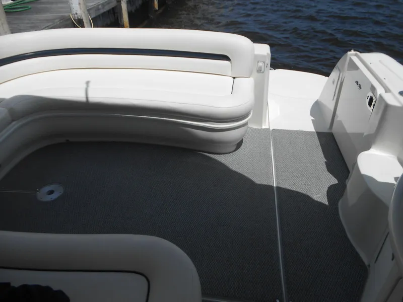 Slide: The Image of 2004 Sea Ray 420 Sundancer boat deck with white seating and gray flooring. - 35