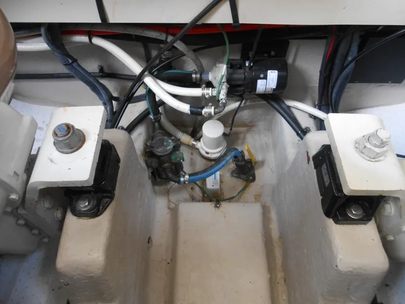 Slide: The Image of Engine compartment of a 2004 Sea Ray 420 Sundancer boat showing various mechanical components. - 36