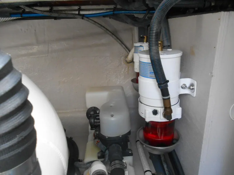Slide: The Image of Engine compartment of a 2004 Sea Ray 420 Sundancer boat showing fuel filters and hoses. - 38