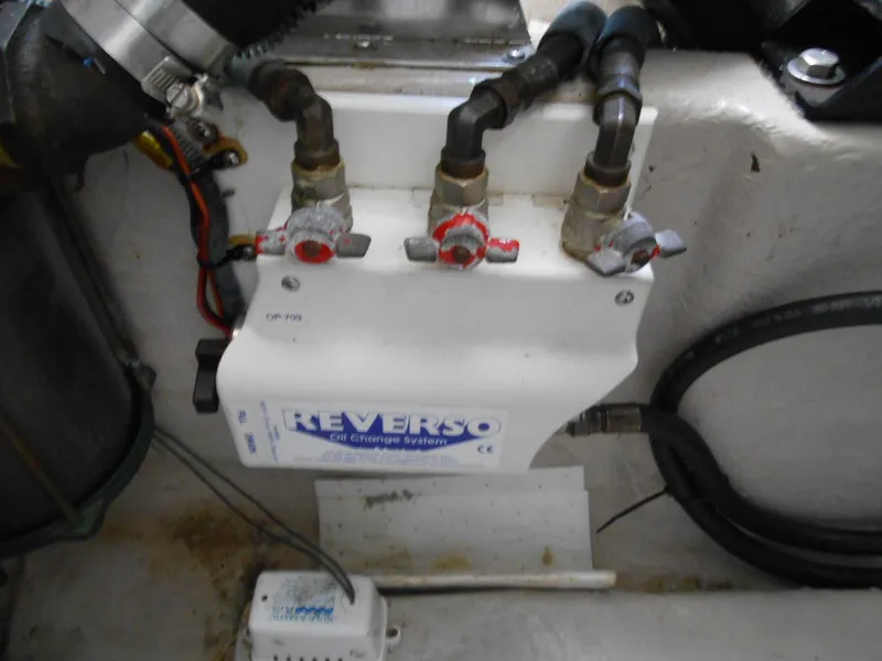 Slide: The Image of Reverso oil change system in a 2004 Sea Ray 420 Sundancer engine compartment. - 44