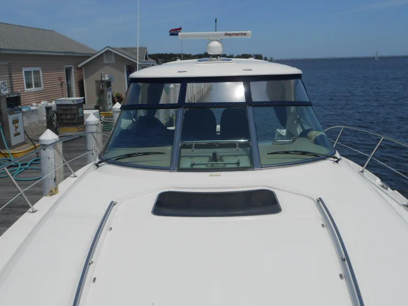 Slide: The Image of 2004 Sea Ray 420 Sundancer yacht docked at a marina. - 9