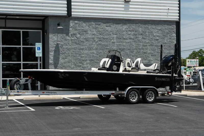 The Image of 2025 ShearWater X22 boat on a trailer in a parking lot. - 1
