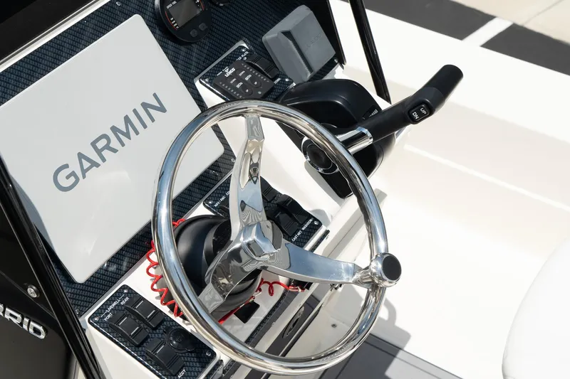 Slide: The Image of ShearWater X22 2025 boat dashboard with Garmin navigation system and steering wheel. - 11