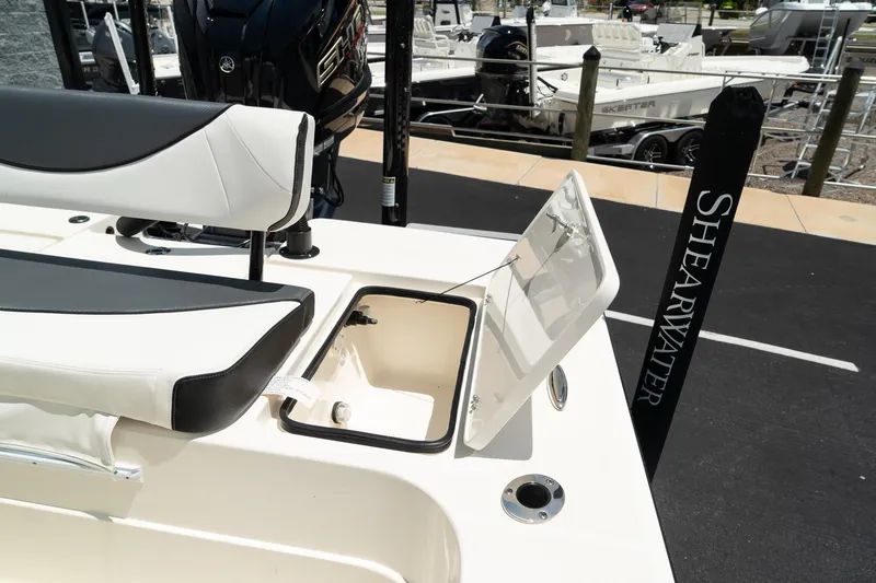 Slide: The Image of 2025 ShearWater X22 boat with open storage compartment and seating. - 16