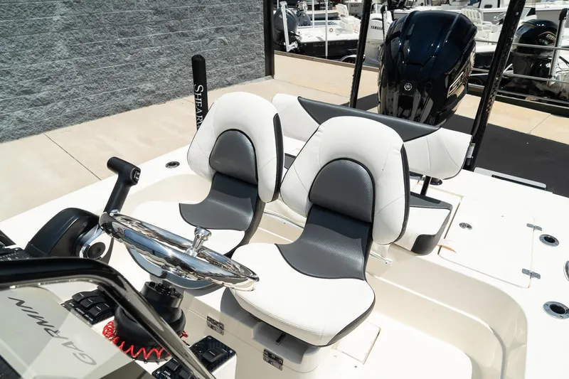 Slide: The Image of 2025 ShearWater X22 boat interior with dual captain's chairs and steering wheel. - 17
