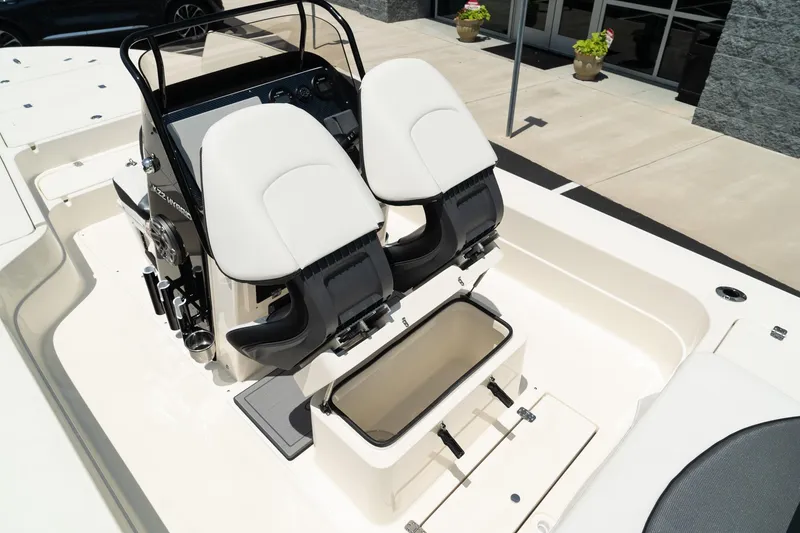 Slide: The Image of 2025 ShearWater X22 boat cockpit with dual seats and storage compartment. - 19