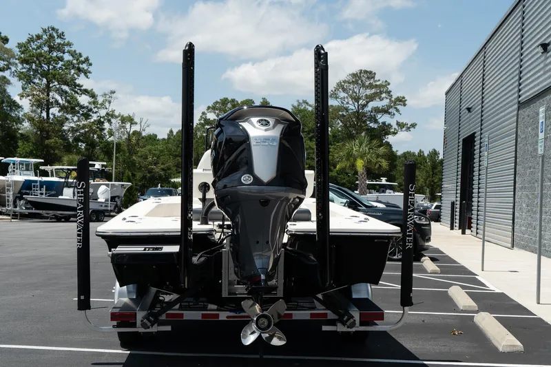 Slide: The Image of 2025 ShearWater X22 boat rear view in parking lot. - 3
