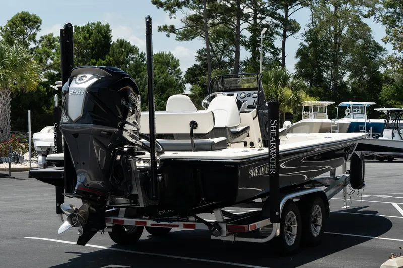Slide: The Image of 2025 ShearWater X22 boat on a trailer in a parking lot. - 4