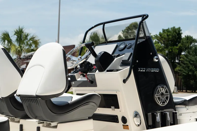 Slide: The Image of 2025 ShearWater X22 Hybrid boat interior with modern dashboard and seating. - 5