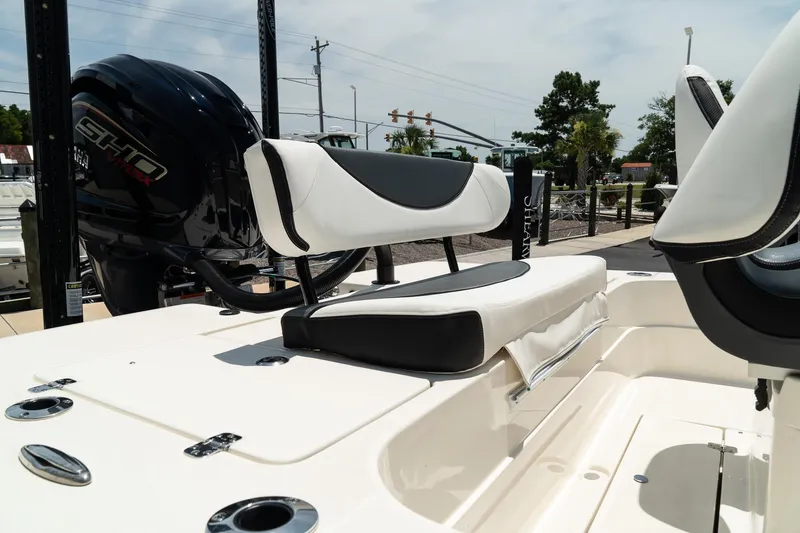 Slide: The Image of 2025 ShearWater X22 boat with cushioned seating and powerful outboard motor. - 6