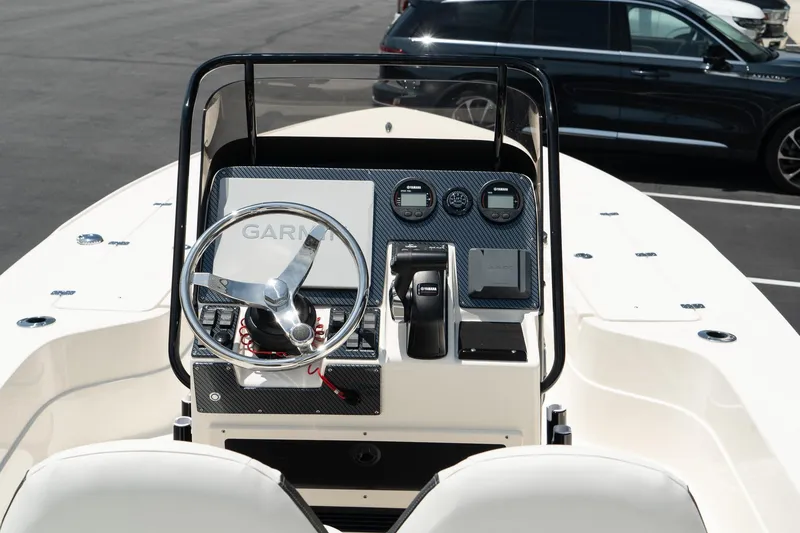 Slide: The Image of 2025 ShearWater X22 boat console with steering wheel and navigation controls. - 9