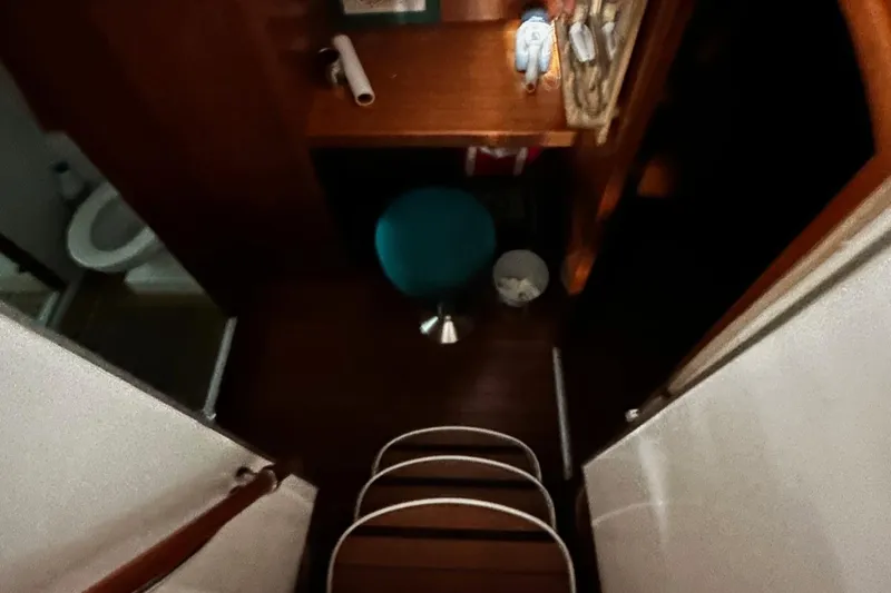 Slide: The Image of Interior view of 2001 Lagoon 380 catamaran, featuring a compact cabin space. - 12