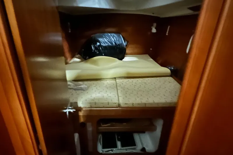 Slide: The Image of Interior cabin of 2001 Lagoon 380 catamaran with wooden finish and bedding. - 16
