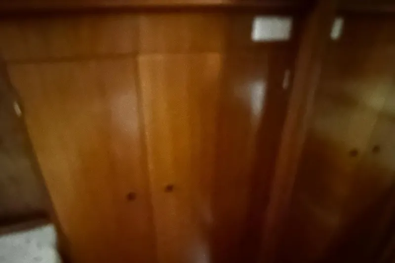 Slide: The Image of Interior of 2001 Lagoon 380 yacht with wooden cabinetry and storage space. - 19