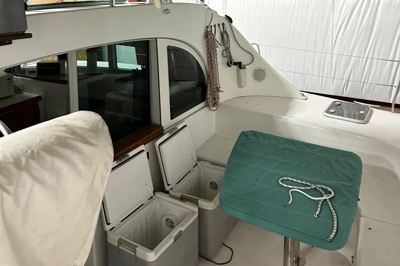 Slide: The Image of Interior view of a 2001 Lagoon 380 catamaran with seating and storage compartments. - 23