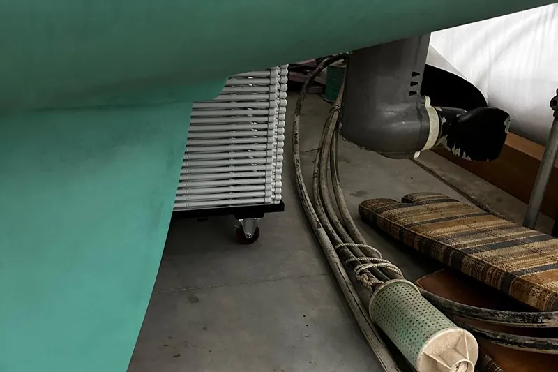 Slide: The Image of Close-up of a 2001 Lagoon 380 catamaran's underside with cables and equipment. - 28