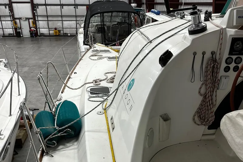 Slide: The Image of 2001 Lagoon 380 catamaran in a warehouse, showcasing deck and equipment. - 29