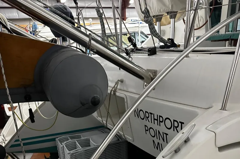 Slide: The Image of 2001 Lagoon 380 catamaran docked indoors, featuring Northport Point MI signage. - 31