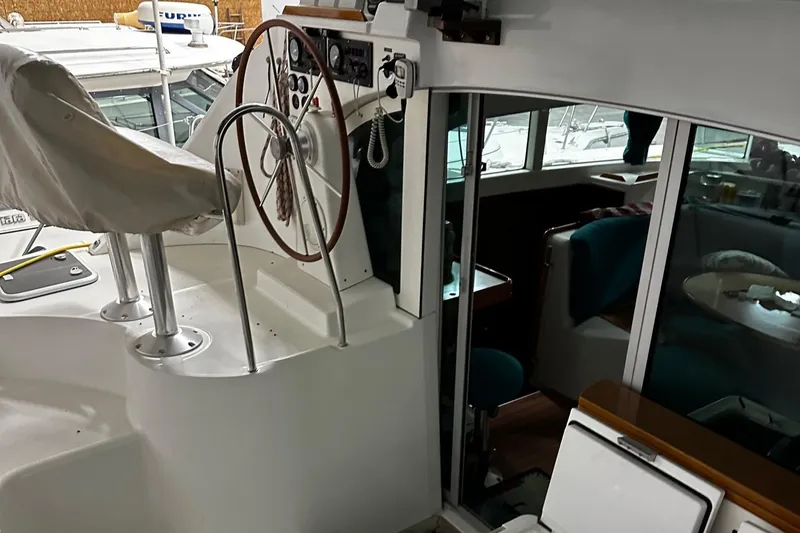 Slide: The Image of 2001 Lagoon 380 yacht interior with steering wheel and seating area. - 6