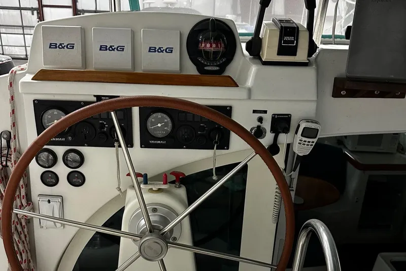 Slide: The Image of Steering wheel and control panel of a 2001 Lagoon 380 catamaran. - 7