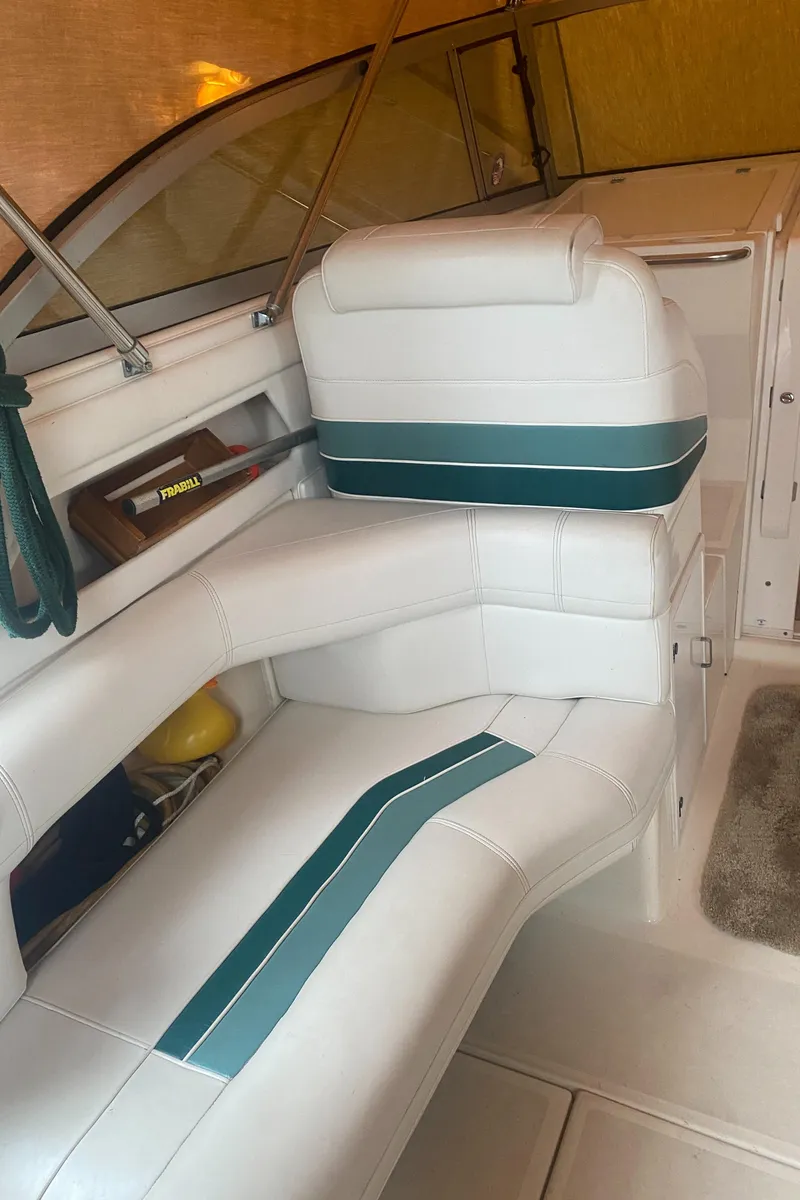 Slide: The Image of 1993 Cruisers 3675 boat interior with white and green seating. - 10