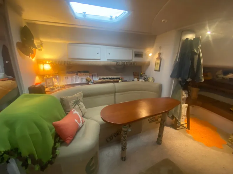 Slide: The Image of 1993 Cruisers 3675 yacht interior with cozy seating and wooden table. - 18